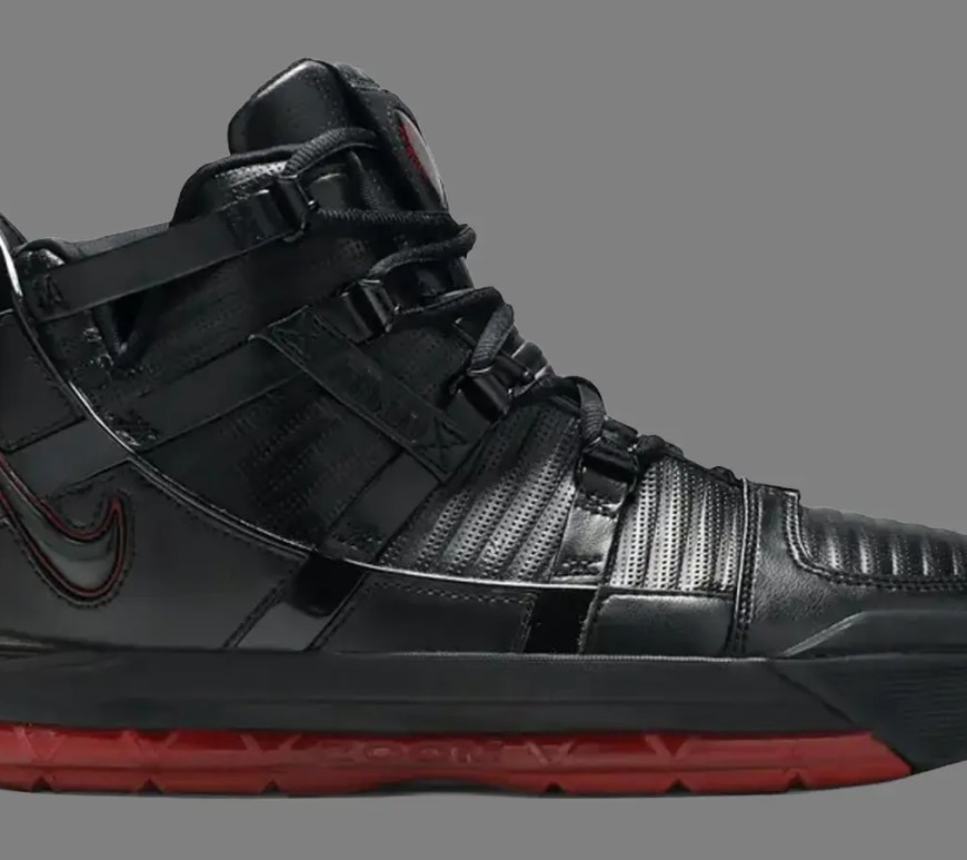 clean product profile shot showcasing the rugged, industrial leather shell, metallic eyelets, and visible full-length Zoom Air window of the 2005 Nike Zoom LeBron III basketball shoe.