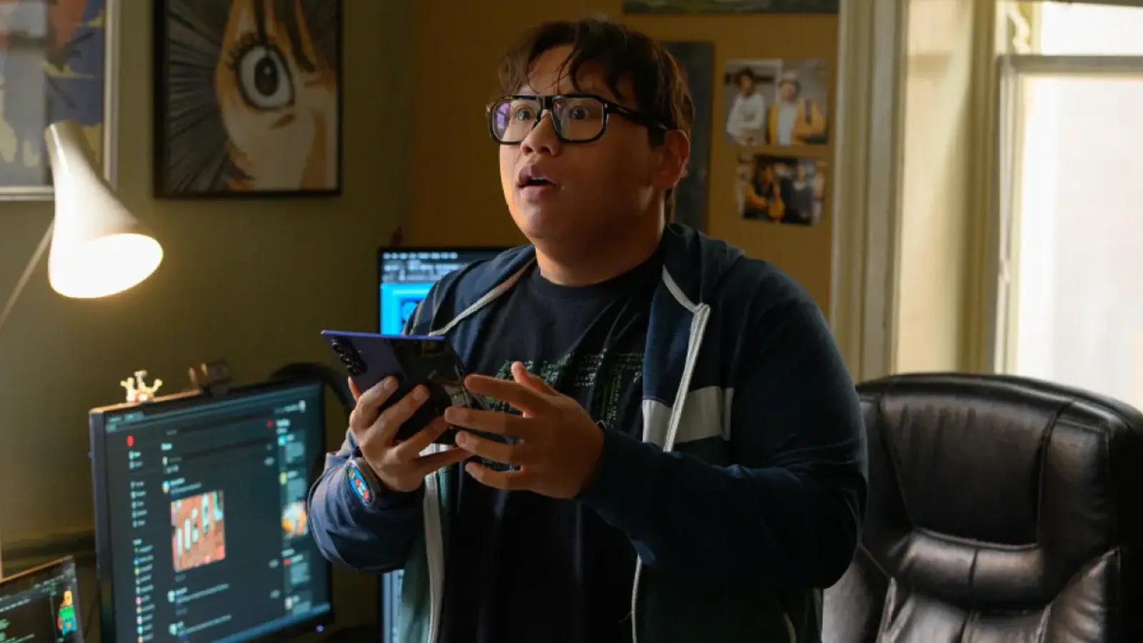An eye-level shot of Ned Leeds holding an open Samsung Galaxy Z Fold smartphone in Spider-Man: A Brand New Day (2026)