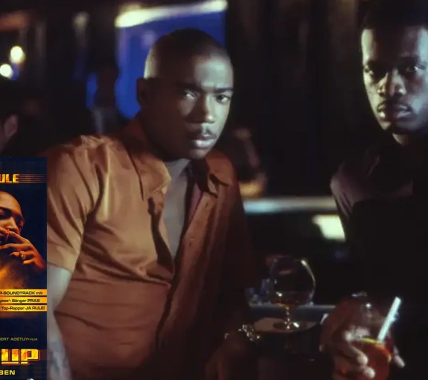 A dark, high-contrast promotional scene frame from the 2000 movie Turn It Up, capturing Ja Rule and Pras in a gritty Brooklyn recording studio setting.