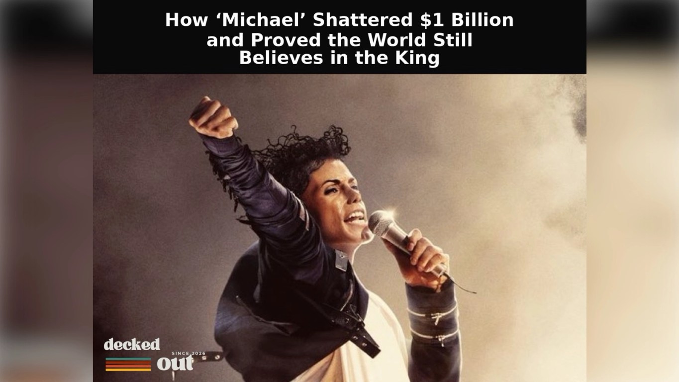 Jaafar Jackson dressed in a black‑and‑white Michael Jackson–style outfit raises one arm in dramatic lighting, with mist behind him and headline text reading ‘How “Michael” Shattered $1 Billion and Proved the World Still Believes in the King,’ alongside a Decked Out logo.