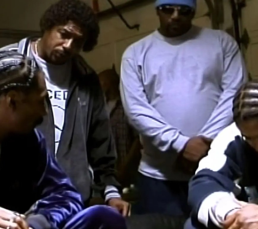 A horizontal vintage promotional group photograph from 2000 featuring Snoop Dogg, Tray Deee, and Goldie Loc dressed in classic blue LBC streetwear styling against a clean studio backdrop.