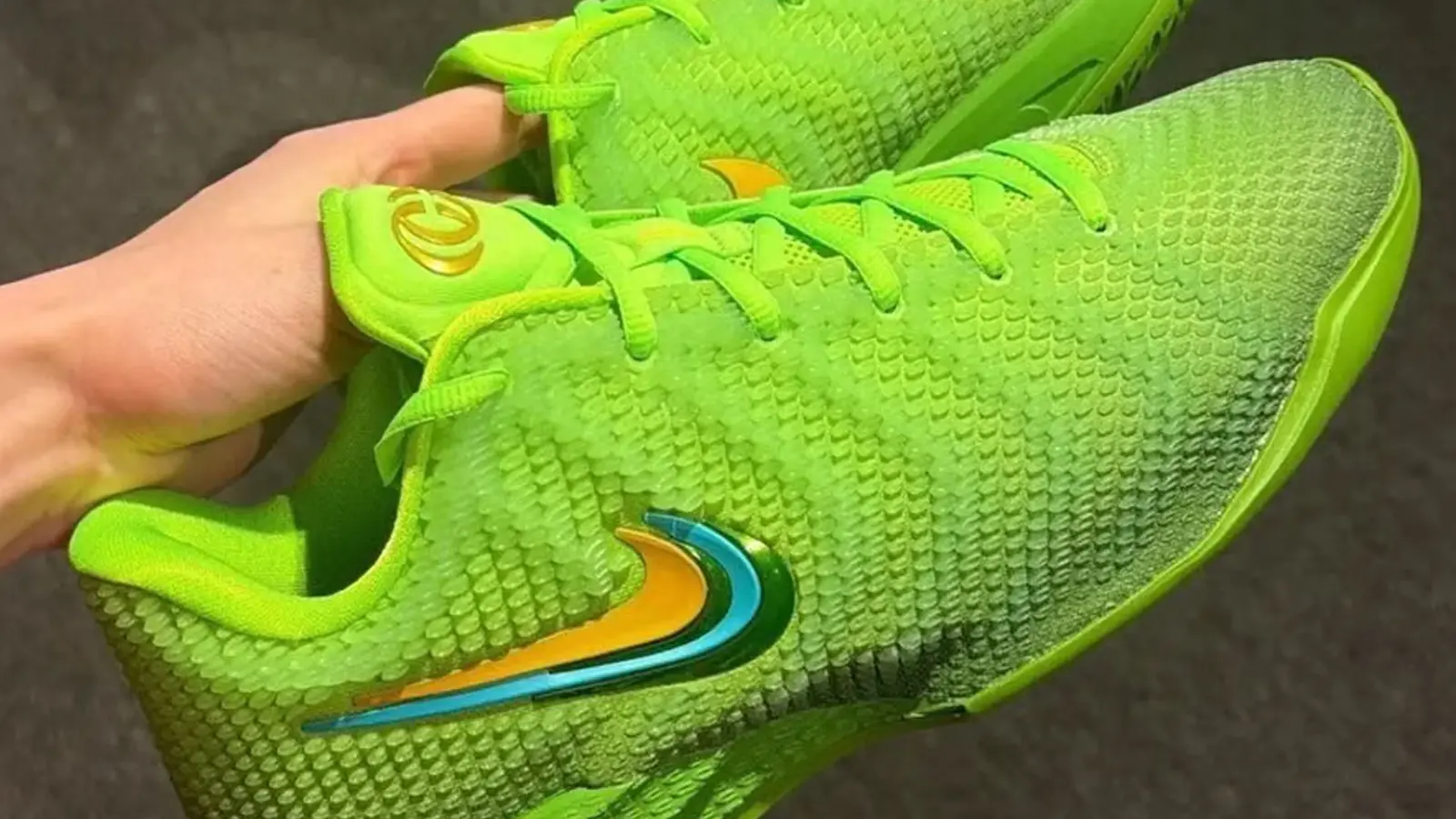 A close-up look at the Caitlin Clark Electric Green colorway reflecting a green upper and green laces with a metallic swoosh